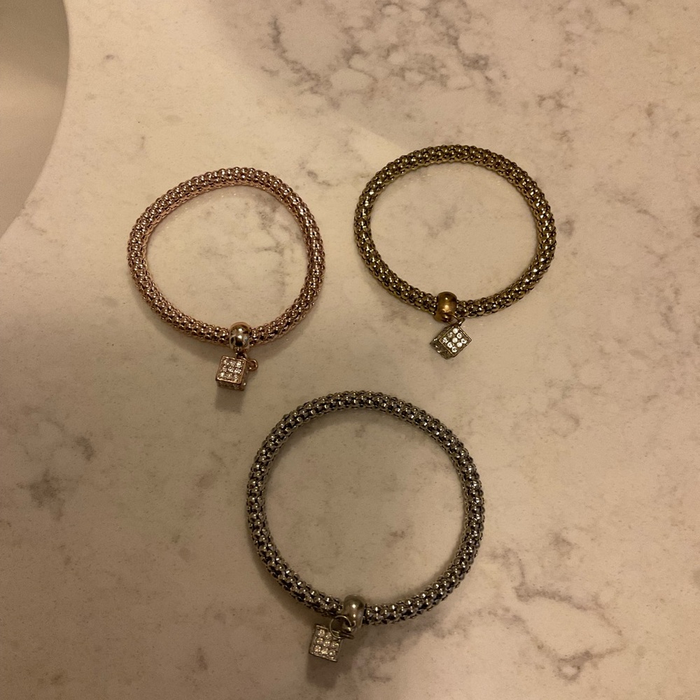 Set of Three Metallic Bracelets with Charms